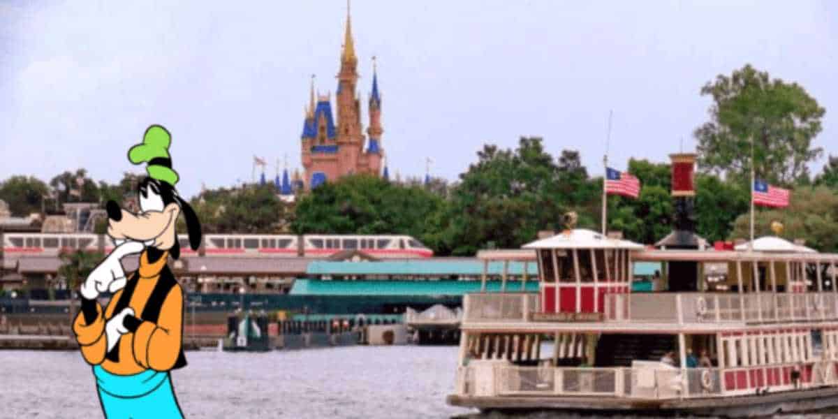 An illustration of Goofy stands by the water in front of a boat dock and monorail vs. ferry boat area, with the iconic Cinderella Castle in the background at Walt Disney World. The scene captures a lively, family-friendly atmosphere.