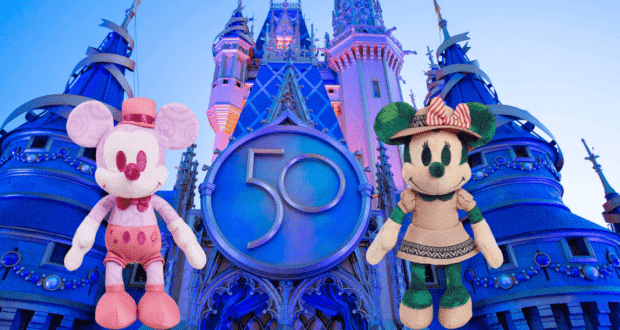 Mickey and Minnie Mouse plush toys styled in vintage Disney fashion pose together in front of Cinderella Castle adorned with a sparkling "50" anniversary emblem, celebrating Walt Disney World’s magical milestone—an ideal collectible or gift for Disney fans, now available on Amazon.