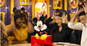 Guests beam with excitement as they put on iconic Mickey Mouse ears, embodying the magic of Disney Traditions; front and center, Mickey Mouse himself grins cheerfully before a vibrant, colorful backdrop.