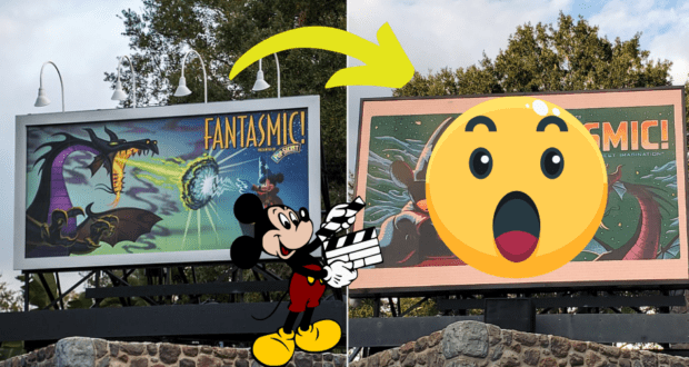Mickey Mouse points excitedly at a Fantasmic! billboard along Sunset Boulevard in Disney's Hollywood Studios, as the billboard image fades dramatically. A giant surprised emoji partially covers the faded sign, adding to the intrigue for park guests.