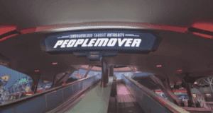 The PeopleMover sign welcomes guests above the escalators in Tomorrowland at Magic Kingdom, featured in the PeopleMover Florida Theme Park Injury Report.