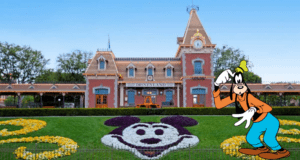 Goofy greets visitors beside the iconic Mickey Mouse floral display at Disneyland’s entrance, setting the stage for an unforgettable day of thrills and enchantment as guests kick off their Disney adventure with reserved tickets.