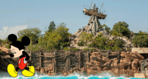 Mickey Mouse strolling in front of Disney’s Typhoon Lagoon, with the iconic shipwreck perched atop Mount Mayday and vibrant refurbishments underway, radiating excitement for theme park fans.