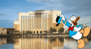 Donald Duck greets fans with a big smile in front of Disney’s lakeside resort, its yellow and white facade gleaming, while promoting exclusive Disney Visa Cardmember magic for guests.