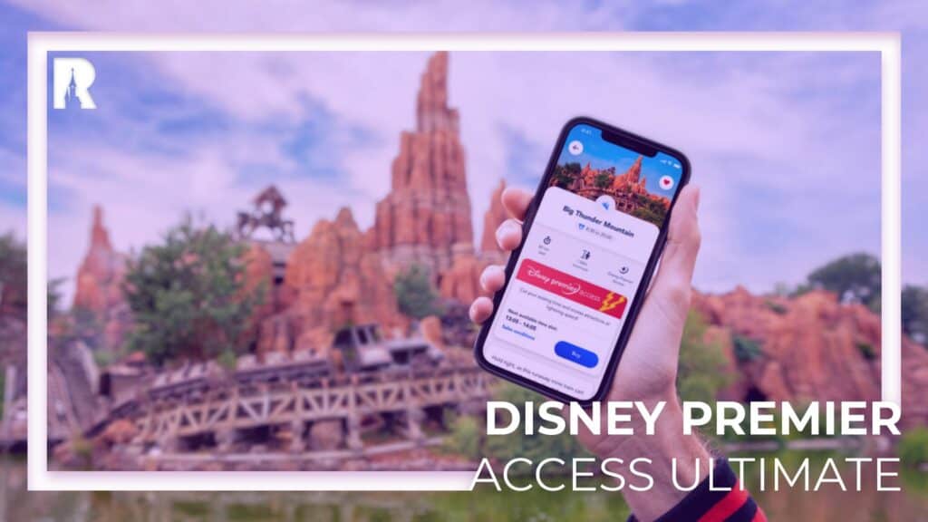 A guest at a Disney park holds up a phone displaying the Disney app with Premier Access Ultimate featured, as the iconic roller coaster and rocky mountain of Big Thunder Mountain Railroad blur in the background.