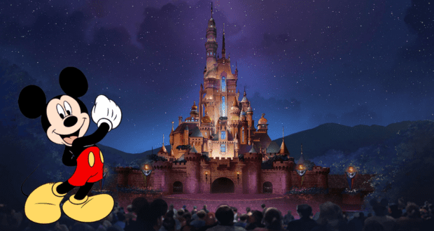 Mickey Mouse greets excited fans in front of a dazzlingly illuminated castle at night, creating magical memories for the crowd at Hong Kong Disneyland.