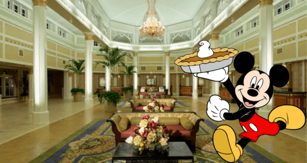 Mickey Mouse presents a festive pie in the grand lobby of a Disney resort, surrounded by elegant furnishings and sparkling chandeliers, bringing the enchantment of a Thanksgiving celebration to life for Disney fans.