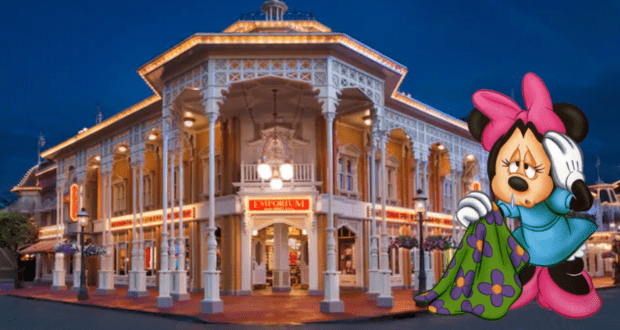 Minnie Mouse, dressed in cozy pajamas, lets out a big yawn in front of the dazzlingly lit and ornate Main Street facades at night, capturing all the charm and whimsy of the beloved Main Street Trolley Show.
