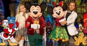 Mickey Mouse, Minnie Mouse, Donald Duck in a Santa outfit, and Pluto greet guests amid holiday decorations at a festive Disney Parks celebration featured in the ABC Disney Holiday Specials.