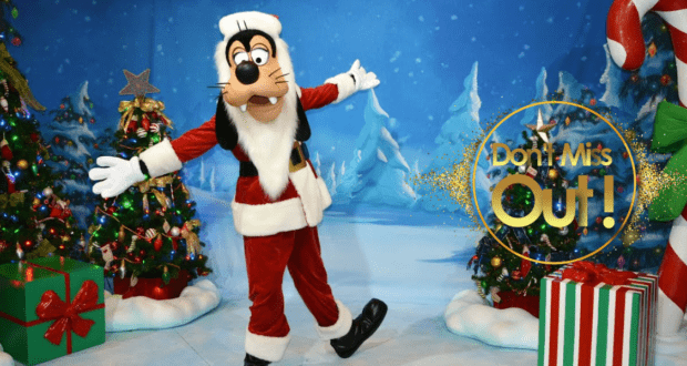 Goofy dressed as Santa Claus greets guests in a snow-dusted holiday scene, surrounded by twinkling Christmas trees and wrapped presents, bringing the festive magic of Walt Disney World to life.