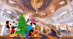 Mickey and Minnie add festive touches to a Christmas tree surrounded by gifts in the opulent hotel lobby aboard Disney Wish, filling the space with holiday magic that fans of Disney Parks and resorts will instantly recognize.