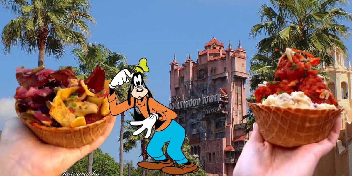 Goofy strikes a playful pose between two guests holding Waffle Bowls on Hollywood Boulevard at Disney's Hollywood Studios, with iconic palm trees and the Hollywood Tower Hotel rising in the background.