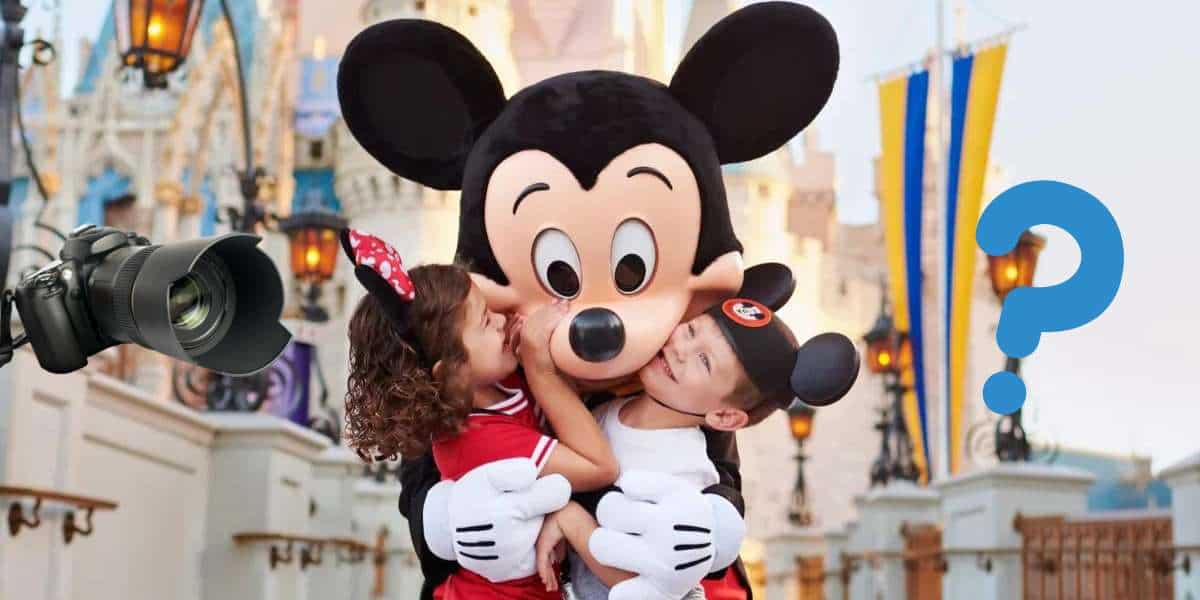 Two kids excitedly hug Mickey Mouse at Disney World, outdoors in a lively setting. A camera and a question mark are added to highlight the magic of capturing unforgettable moments with Memory Maker.