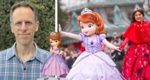 A Disney fan sporting glasses poses at a lively outdoor event with Sofia the First character art and a performer dressed as Sofia herself, likely celebrating exciting updates about a new Sofia the First spinoff in the Disney franchise.