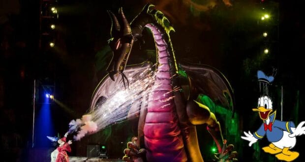 Maleficent the dragon breathes fire across the Fantasmic! stage under the night sky, while Donald Duck appears in animated form at the lower right, capturing an unforgettable Disney World spectacle.