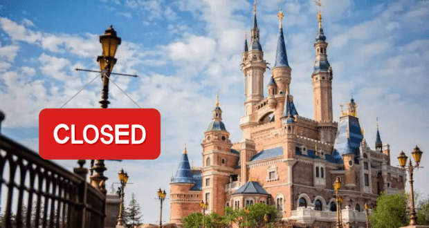The Enchanted Storybook Castle at Shanghai Disneyland, prominently marked with a bold red "CLOSED" sign out front, set against a bright blue sky dotted with fluffy clouds.