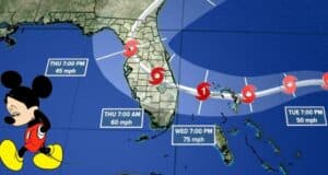 Mickey Mouse stands by a hurricane forecast map, highlighting Subtropical Storm Nicole as it heads toward Florida and the Walt Disney World resort.