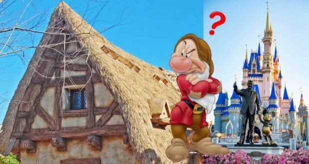 Grumpy from Snow White stands between the charming thatched cottage and the iconic castle at Magic Kingdom, sporting a puzzled expression as a bright red question mark hovers nearby.