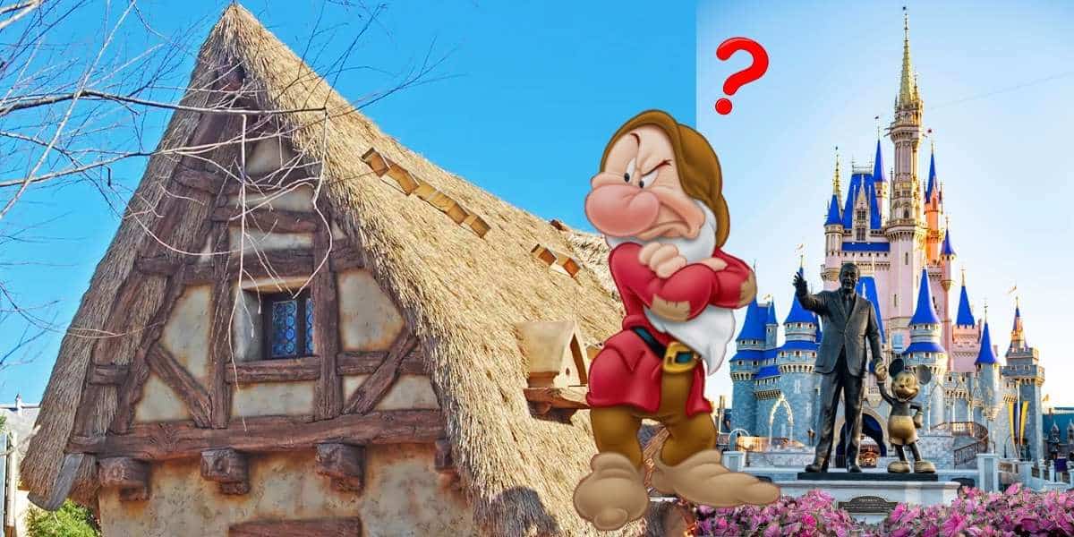 Grumpy from Snow White stands between the charming thatched cottage and the iconic castle at Magic Kingdom, sporting a puzzled expression as a bright red question mark hovers nearby.