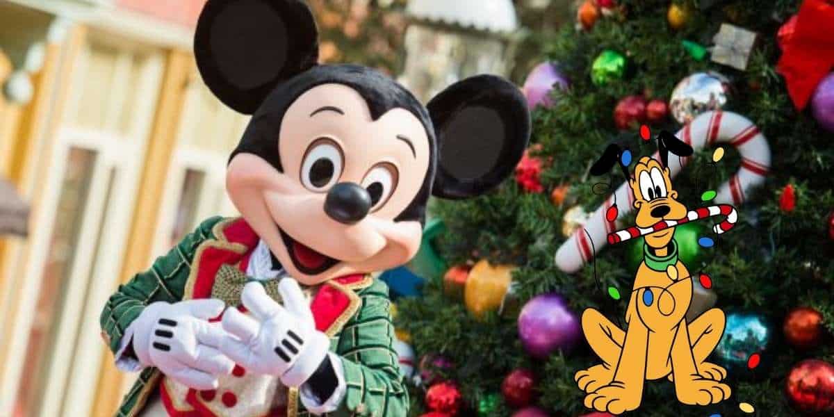 Mickey Mouse in festive holiday attire stands by a decorated Christmas tree, with Pluto holding a candy cane in his mouth, surrounded by Christmas lights—perfect for adding Disney holiday magic to your home or as a charming free gift.