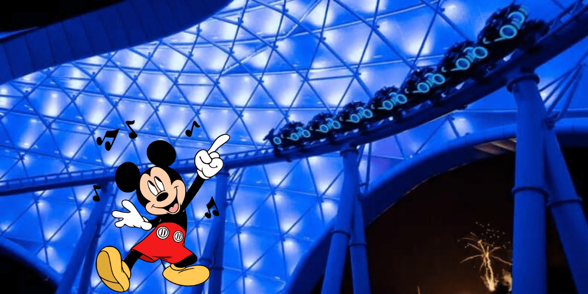 Mickey Mouse brings the magic to life as he dances under the night sky in front of the glowing blue Tron Lightcycle Run roller coaster at Disney World, with thrilled guests racing by on the high-speed attraction.