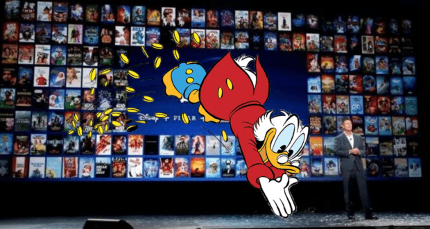 Scrooge McDuck dives into a pile of coins onstage at a Disney event, with a backdrop of large movie posters highlighting his famous adventures now streaming on Disney Plus, capturing that classic Disney magic for fans.