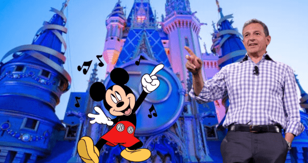 Mickey Mouse gestures enthusiastically in front of a dazzling, blue-lit Cinderella Castle at Disney World, surrounded by playful musical notes, setting the stage for buzz about a potential Bob Iger-Apple partnership.