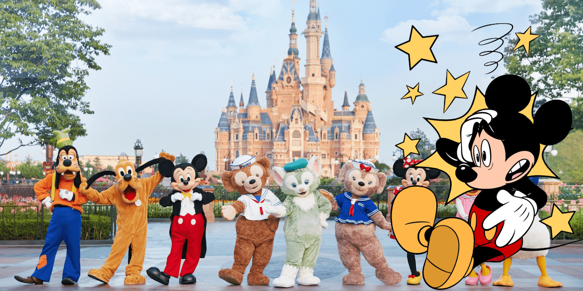 Mickey Mouse appears a bit dizzy, cartoon stars swirling above his head, as he joins other beloved Disney characters posing in front of the iconic castle at Shanghai Disneyland.