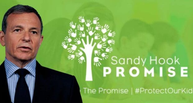 Disney CEO Bob Iger stands next to the Sandy Hook Promise logo and slogan, set against a green backdrop where children are softly blurred, emphasizing his commitment to gun safety advocacy within the entertainment industry.