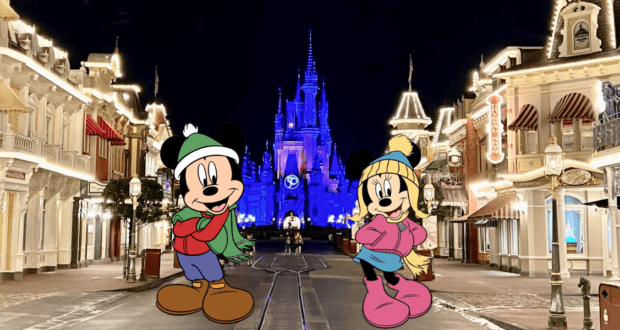 Mickey and Minnie, bundled up in festive winter attire, celebrate the chilly weather amid twinkling lights on Main Street at Walt Disney World. Behind them, Cinderella Castle glows a brilliant blue against the night sky, creating an enchanting holiday scene for park guests.