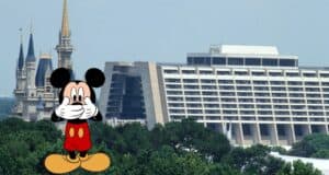 Mickey Mouse greets guests in front of Disney World’s iconic castle and a nearby modern resort hotel, nestled among lush trees, blissfully unaware of the buzz around the recent Disney World Pizza Scam.