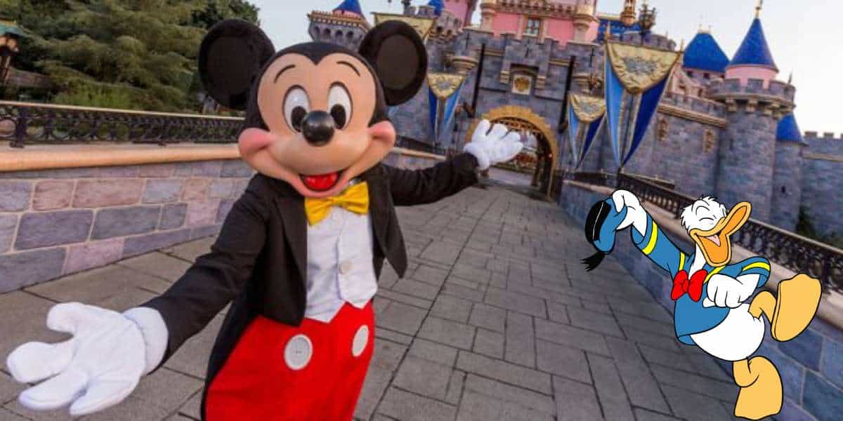 Mickey Mouse stands in front of the iconic Disney castle, with Donald Duck nearby waving to guests, showcasing the unforgettable magic and fun that Disney Park Tickets bring to your visit.
