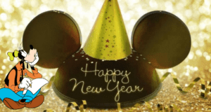 Goofy excitedly writes his New Year's Resolutions with a pencil, surrounded by dazzling Disney party decorations and a festive Mickey hat, all sparkling against a glamorous gold backdrop—capturing the vibrant energy of Disney Parks as they ring in the New Year.