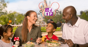A Disney World family donning iconic Mickey ears shares a joyful outdoor meal with Cinderella Castle serving as the perfect backdrop, showing off their Disney Dining Plan experience.