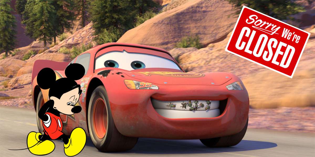 Mickey Mouse stands with a forlorn expression beside Lightning McQueen from Pixar Cars, under a prominent "Sorry, We're Closed" sign, embodying the unmistakable emptiness and disappointment fans feel when Disney Parks aren’t open.