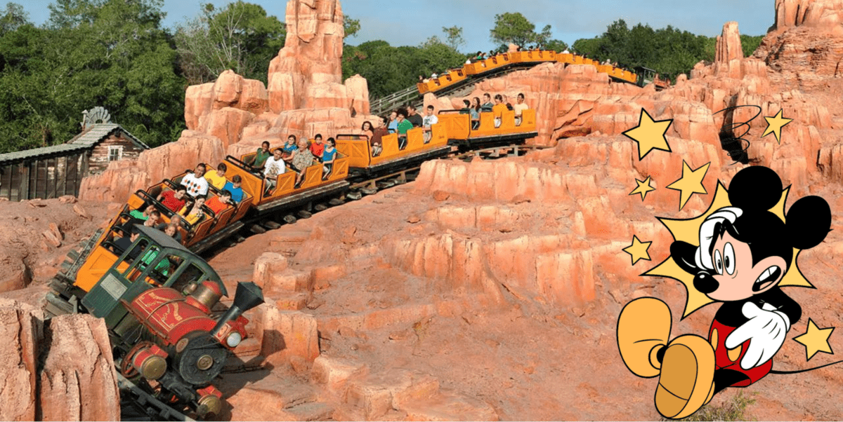 Big Thunder Mountain Railroad thrills guests as its train climbs dramatic red rock hills, packed with excited riders; on the right, Mickey Mouse adds Disney magic, highlighting the wild adventure of this iconic attraction.