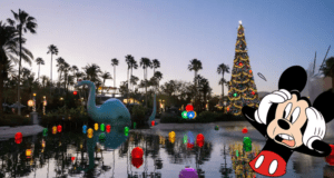 Mickey Mouse appears delighted, gazing at a sparkling Christmas tree and vibrant holiday decorations as colorful lights twinkle by the lakeside at dusk, bringing Disney World’s festive wonder to life.