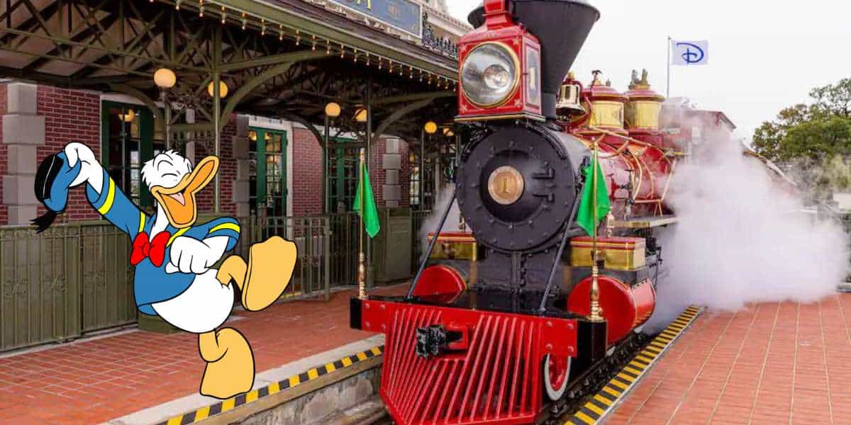 Donald Duck enthusiastically greets guests by the classic red steam engine at the Walt Disney World Railroad station, with clouds of steam adding to the excitement of this beloved park experience.