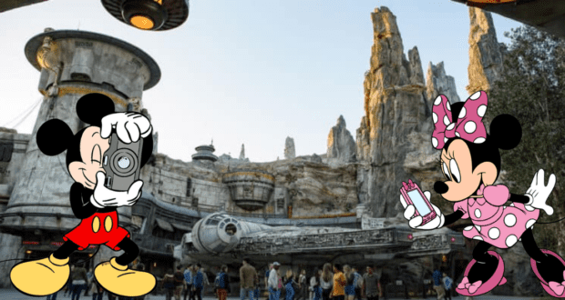 Mickey Mouse snaps a photo of Minnie Mouse at Star Wars: Galaxy’s Edge, the immersive Disney park where ASL interpreters enhance accessibility, surrounded by crowds and iconic Star Wars spaceships in the background.