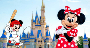 Minnie Mouse greets guests in front of the castle as Mickey Mouse, dressed in baseball gear after spring training at ESPN Wide World of Sports, takes a swing with his bat nearby.