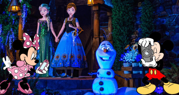 Minnie Mouse jots down notes as Mickey Mouse snaps photos of Anna, Elsa, and Olaf’s animatronics from Frozen onstage at Walt Disney World. Josh Gad’s beloved voice acting brings Olaf to life in this magical theme park moment.