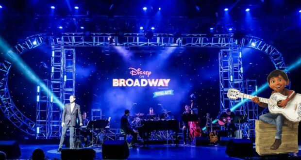 The Disney on Broadway stage lights up as a talented singer joins musicians for an unforgettable performance, while Miguel from Coco strums his guitar, captivating the audience in true Disney magic.