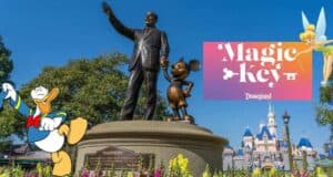 The iconic Partners statue of Walt Disney and Mickey Mouse stands proudly alongside Donald Duck and Tinker Bell, with the Magic Key Disneyland logo highlighting this magical scene.