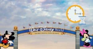 The iconic Walt Disney World entrance greets guests as a somber-looking Mickey and Minnie stand beneath the archway, while clocks and hourglass icons float above, playfully highlighting the famously long wait times at the park.
