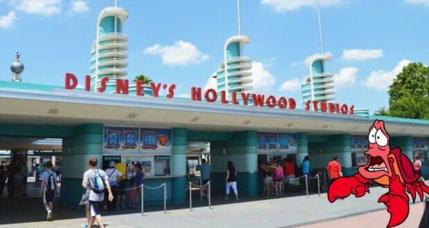 Guests make their way through the iconic entrance of Disney's Hollywood Studios, with Sebastian the crab welcoming them in the foreground—a perfect introduction to The Voyage of the Little Mermaid attraction.