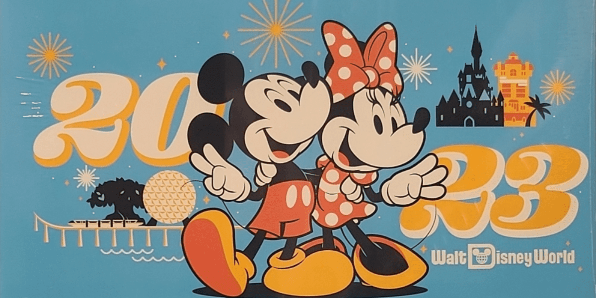Mickey and Minnie greet guests with big smiles in front of a bold “2023” display, surrounded by iconic Walt Disney World landmarks and a dazzling fireworks show in the background.
