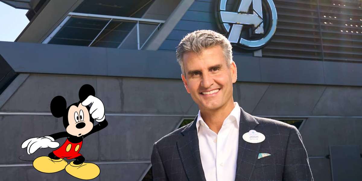 A smiling man in a suit stands next to the Avengers logo as Mickey Mouse waves enthusiastically in the foreground, celebrating the dedication and joy of Disney cast members who create unforgettable moments at Disney parks every day.