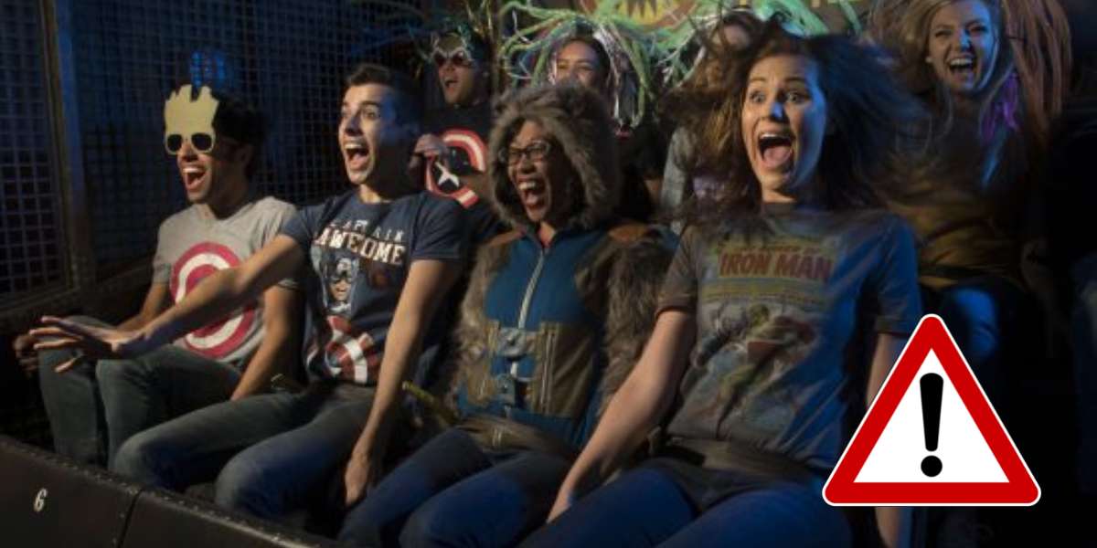 Marvel fans in Guardians of the Galaxy attire let loose with excited screams on an exhilarating ride at a theme park, captured in a TikTok-worthy thrill moment, with a warning icon featured in the bottom right corner.