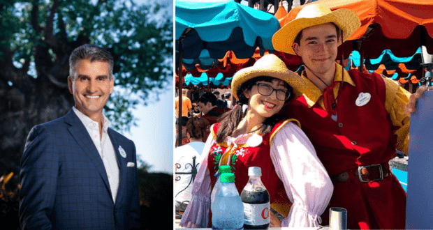 Josh D’Amaro beams in a suit alongside two energetic Cast Members in vibrant Disney costumes, all sharing smiles for the camera—a positive scene that stands out amid recent Disney Parks layoff news.
