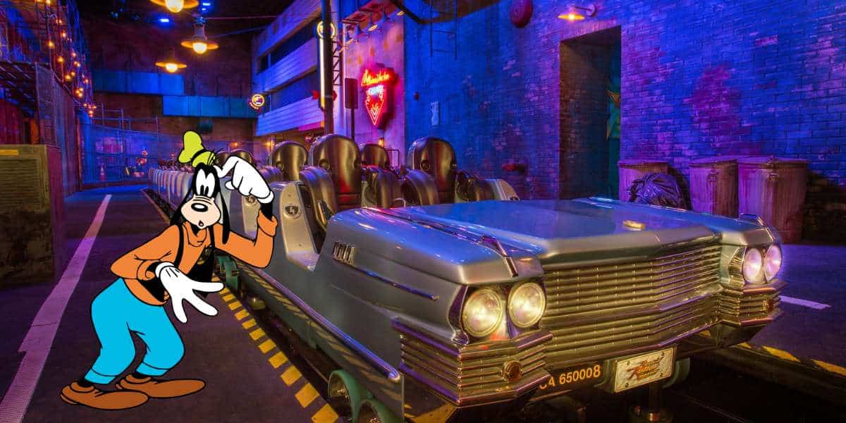 Goofy poses next to an empty ride vehicle inside a dazzling, neon-lit attraction bursting with the electric energy and bold colors reminiscent of Disney’s Rock 'n' Roller Coaster Starring Aerosmith.